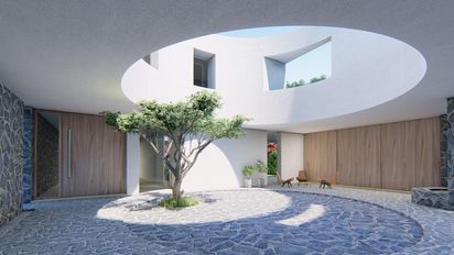 Un patio circular es nexo de bienvenida a una casa