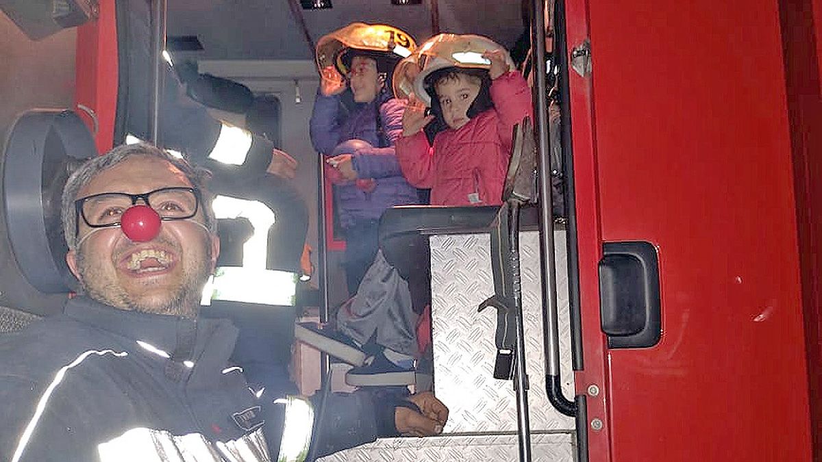 Mariano en su doble rol de bombero voluntario y payaso para contener a los niños.